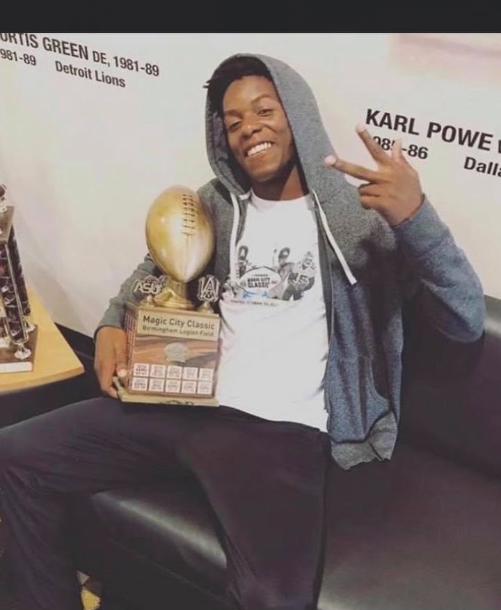 Marquez Spencer holding the Magic City Classic trophy